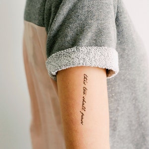 May include: A person's arm with a tattoo that reads "this too shall pass".