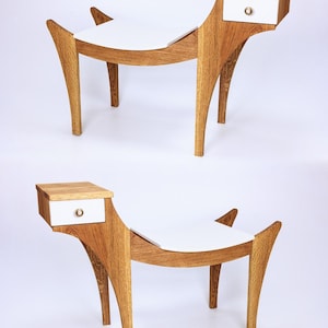 May include: Two wooden stools with a white top and a small drawer on the side. The stools have a unique curved design and are made of light brown wood.