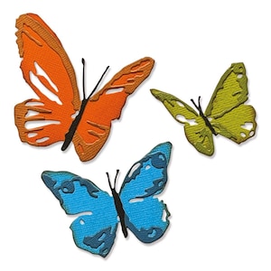 Puede incluir: Tres mariposas de papel en diferentes colores y diseños. Las mariposas son naranja, azul y verde.