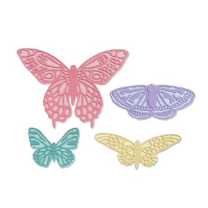 Puede incluir: Cuatro mariposas de papel decorativas en varios colores y tamaños. Las mariposas están recortadas en papel y tienen un diseño delicado e intrincado. Las mariposas son rosas, azul claro, amarillas y moradas.