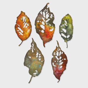 May include: Five decorative metal leaf cutouts in shades of orange, green, and brown. Each leaf has a unique shape with intricate cut-out patterns, creating a textured and artistic appearance. The leaves are arranged against a plain white background.