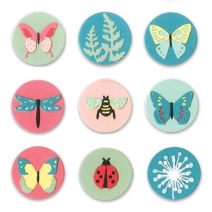 May include: Nine colourful round paper circles with various nature-themed designs. Each circle features a different insect or plant, including a butterfly, dragonfly, bee, ladybug, fern, and dandelion.