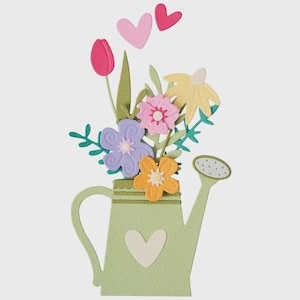 May include: A papercraft design showing a light green watering can filled with colourful paper flowers. The flowers include a pink tulip, purple, pink, and yellow blooms. Two pink hearts float above the watering can. A white heart is on the watering can.