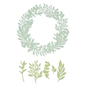 May include: A die-cut wreath and several leaf sprigs in shades of green. The wreath is a circular design of leaves and small flowers. The sprigs vary in shape and size, with detailed leaf patterns. All elements are on a white background.