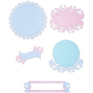 May include: Set of five decorative paper cutouts in blue and pink. The cutouts include a large circle, a smaller circle, an oval, a rectangle, and a number one. All of the cutouts have a delicate, intricate design.