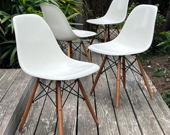 Set of 4 Eames DCS chairs with molded fiberglass shells with wood and metal Eiffel Tower bases