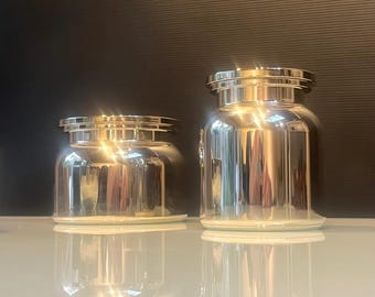 Pair of polished stainless steel lidded canisters
