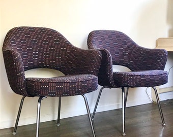 May include: Two mid-century modern chairs with a brown and white geometric patterned upholstery and chrome legs.