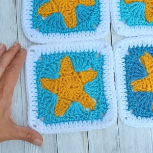 May include: Four crocheted squares with a white border and a yellow star in the center of each square. The squares are made with blue and turquoise yarn.