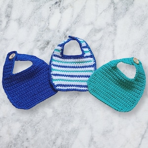 May include: Three crocheted bibs in blue, green, and white stripes. The bibs have a simple design and are perfect for babies and toddlers.