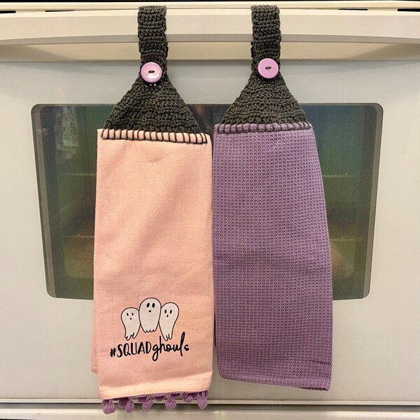 Hanging Halloween tea towel set in pastel pink and purple, cotton dishtowels button on crochet strap with ghosts squad ghouls and pompoms