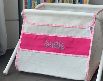 Personalized kid's toy box. Safe. Large capacity. Portable -easily goes anywhere. Made in the USA. White mesh/pink panel/pink check binding.