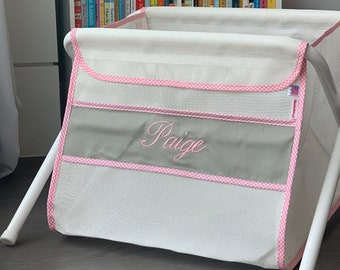 Personalized kid's toy box. Safe. Large capacity. Portable -easily goes anywhere. Made in the USA. White mesh/gray panel/pink check binding.