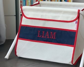 Personalized kid's toy box. Safe. Large capacity. And portable -easily take it anywhere. Made in the USA. White mesh/navy panel.