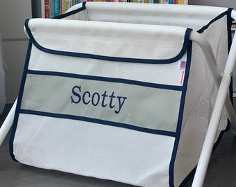 Personalized kid's toy box. Safe. Large capacity. Portable -easily take it anywhere. Made in the USA. White mesh/gray panel/blue binding.