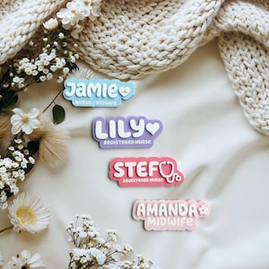 May include: Four colourful name tags with different titles, including "Jamie Nurse/Midwife", "Lily Registered Nurse", "Stef Registered Nurse", and "Amanda Midwife".