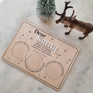 May include: Wooden sign with the text "Dear Santa" and two circles for treats. The text reads "Thank you for visiting our home, here are some treats for you & the reindeer. Love Lach & Arm."  A YUMMY TREAT FOR YOU. A YUMMY CARROT FOR YOUR REINDEER. AND SOMETHING TO WASH THEM DOWN WITH.