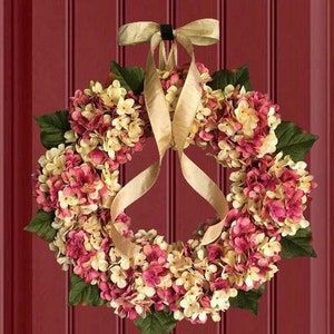 Pink hydrangea wreath on a red door.