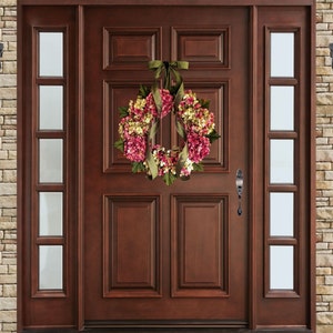 pink spring hydrangea wreath on a wood front door