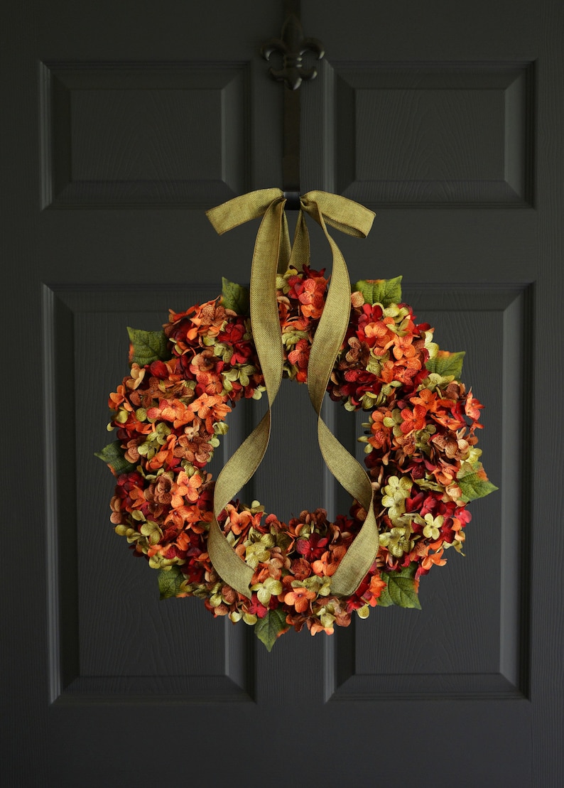 Fall outdoor hydrangea wreath on a black cottage door.