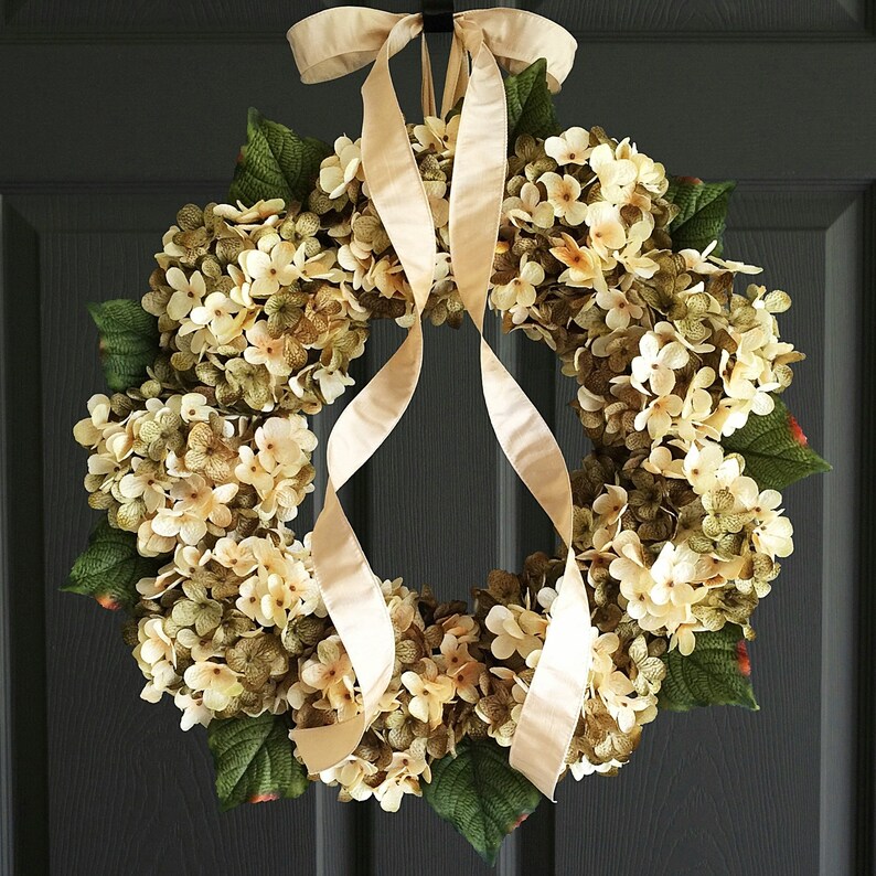 Green hydrangea wreath on a black door.