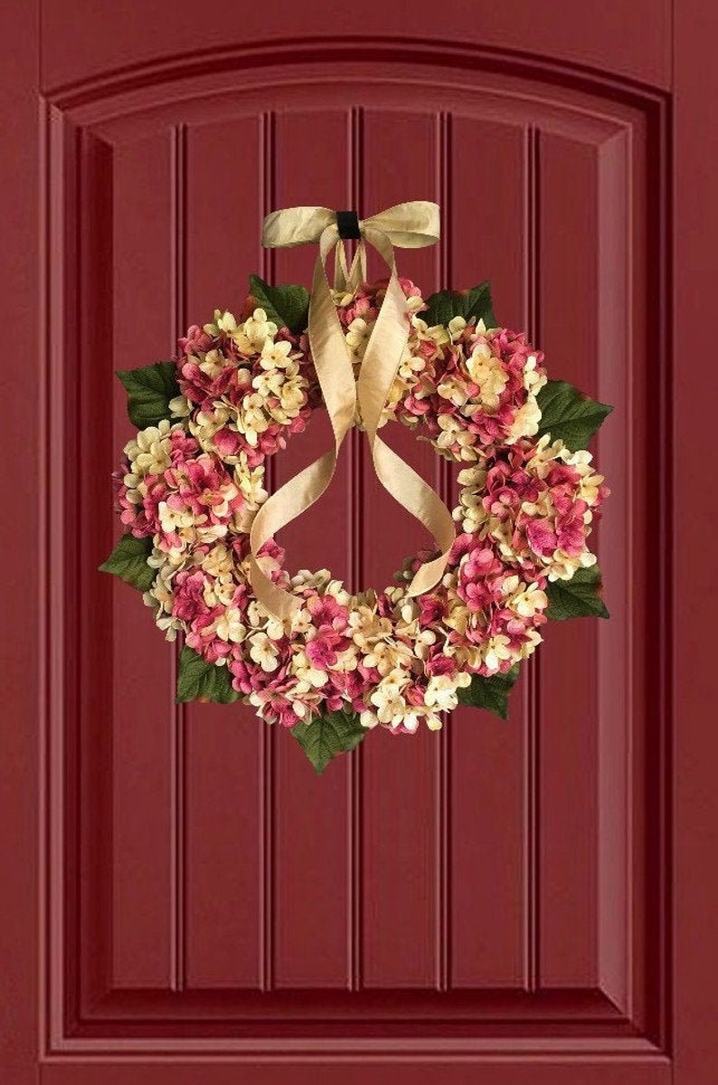 Pink hydrangea wreath on a red door.