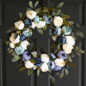 Blue peony wreath on a black door.