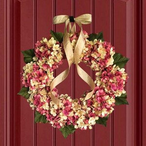 Pink hydrangea wreath on a red door.