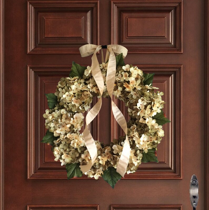 Green hydrangea wreath on a wood door.