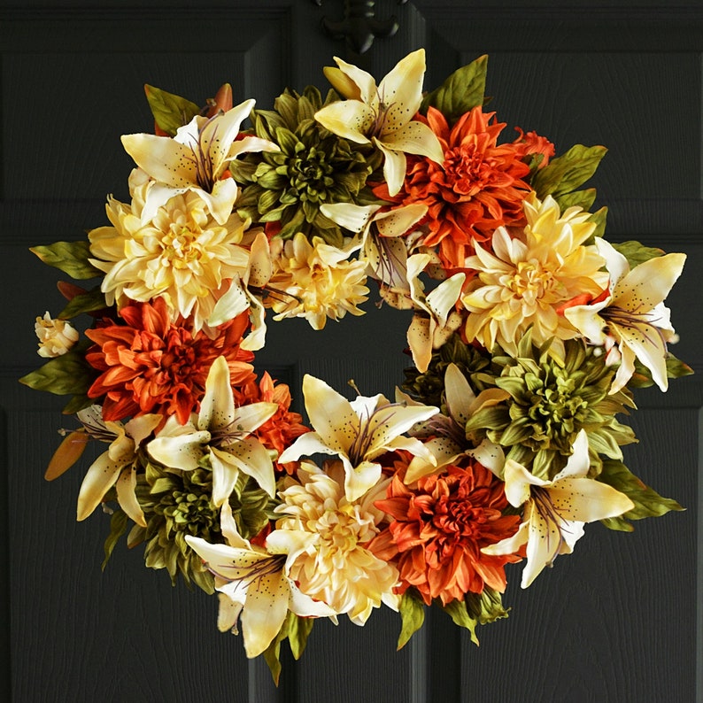 orange dahlia flower wreath with lilies