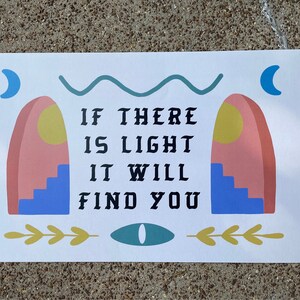 May include: A white poster with a blue, green, and yellow abstract design. The poster has the text "If there is light it will find you".