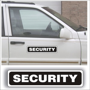 May include: A white vehicle door with a black and white "SECURITY" sign. The sign is rectangular with white text on a black background. The vehicle's window and side mirror are visible.