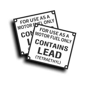 May include: Two white square warning signs with black text. The signs read "FOR USE AS A MOTOR FUEL ONLY" and "CONTAINS LEAD (TETRAETHYL)". Each sign has a black border and four corner holes.
