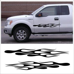May include: Black flame decals for a white truck. The decals are a stylized flame design, suitable for vehicle customization. The image also shows the decals separately, ready for application.