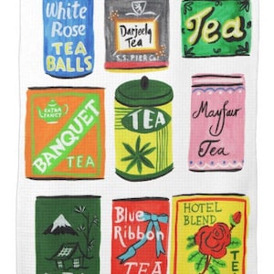 May include: A white tea towel with a colorful illustration of nine tea tins. The tins are labeled with different tea names, including "White Rose Tea Balls", "Darjeeling Tea", "Banquet Tea", "Mayfair Tea", "Blue Ribbon Tea", and "Hotel Blend Tea".