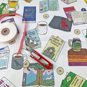 May include: A white background with a variety of book covers, mugs, and other literary-themed items. The items are arranged in a random pattern and include titles such as "The Railway Children", "Treasure Island", "Northern Lights", "The Hobbit", and "Rebecca".