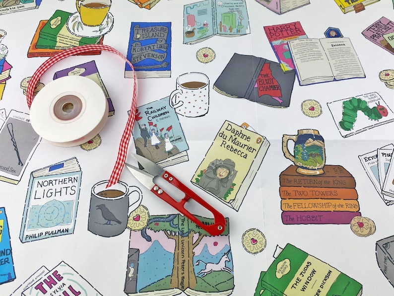 May include: A white background with a variety of book covers, mugs, and other literary-themed items. The items are arranged in a random pattern and include titles such as "The Railway Children", "Treasure Island", "Northern Lights", "The Hobbit", and "Rebecca".