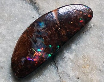 A crescent shape boulder opal rom the opal fields of Winton, Australia