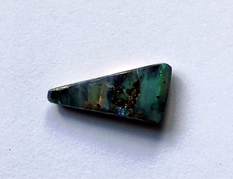 A small Winton boulder opal with an unusual triangular shape