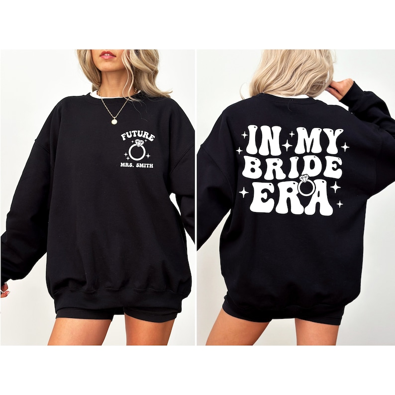 May include: Black sweatshirt with white text that says "Future Mrs. Smith" on the front and "In My Bride Era" on the back. The text is in a retro font with a ring and diamond graphic.