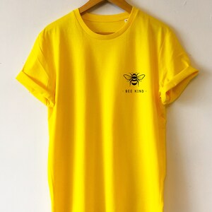 May include: A bright yellow t-shirt with a black bee graphic and the text "BEE KIND" on the front.