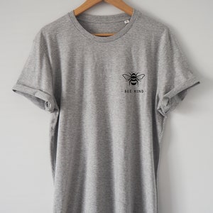 May include: A gray t-shirt with a black bee graphic and the text "BEE KIND" on the front.