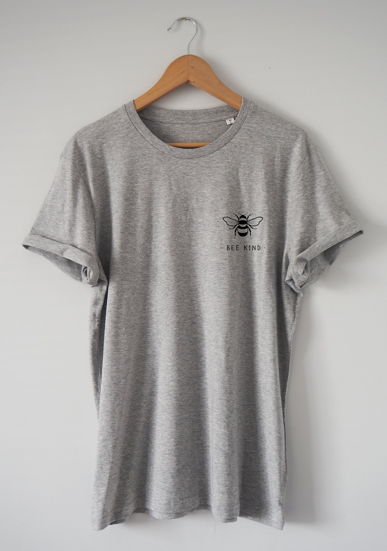 May include: A gray t-shirt with a black bee graphic and the text "BEE KIND" on the front.