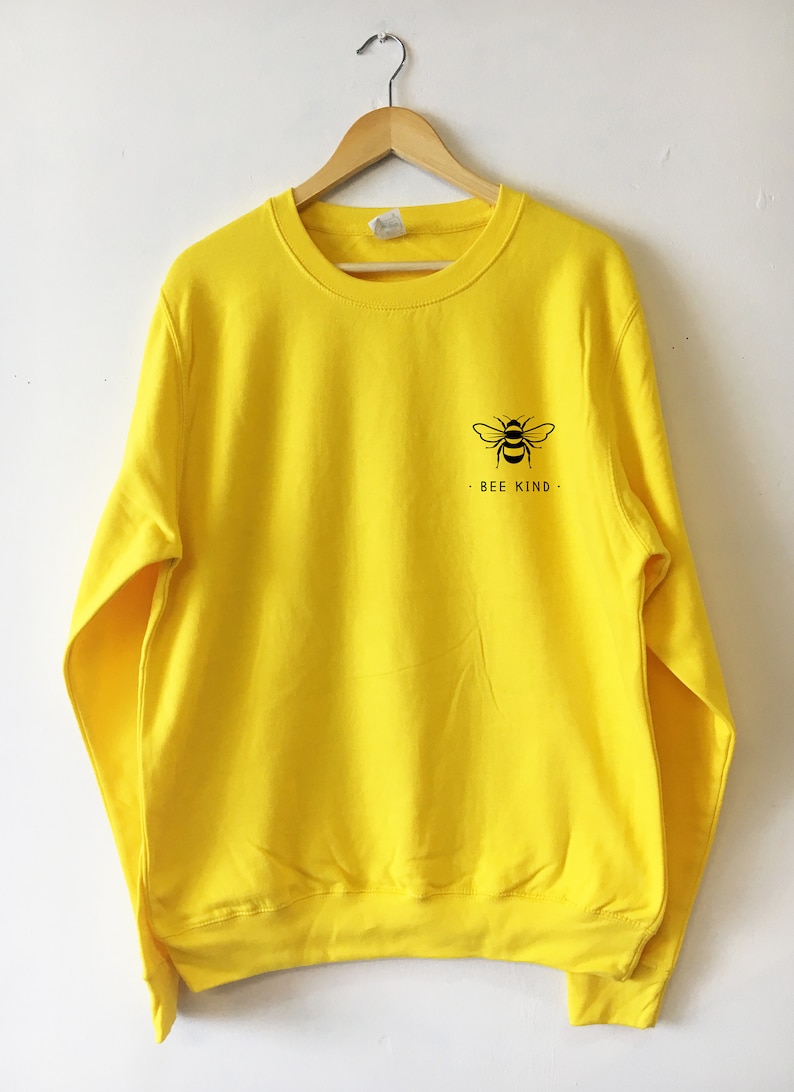 May include: Yellow sweatshirt with a black bee graphic and the text "BEE KIND" on the front.