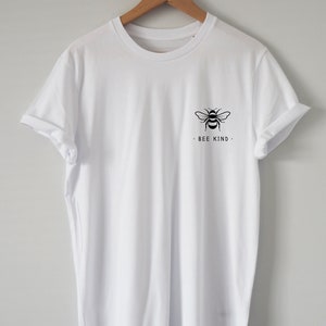 May include: White t-shirt with a black bee graphic and the text "BEE KIND" on the front.