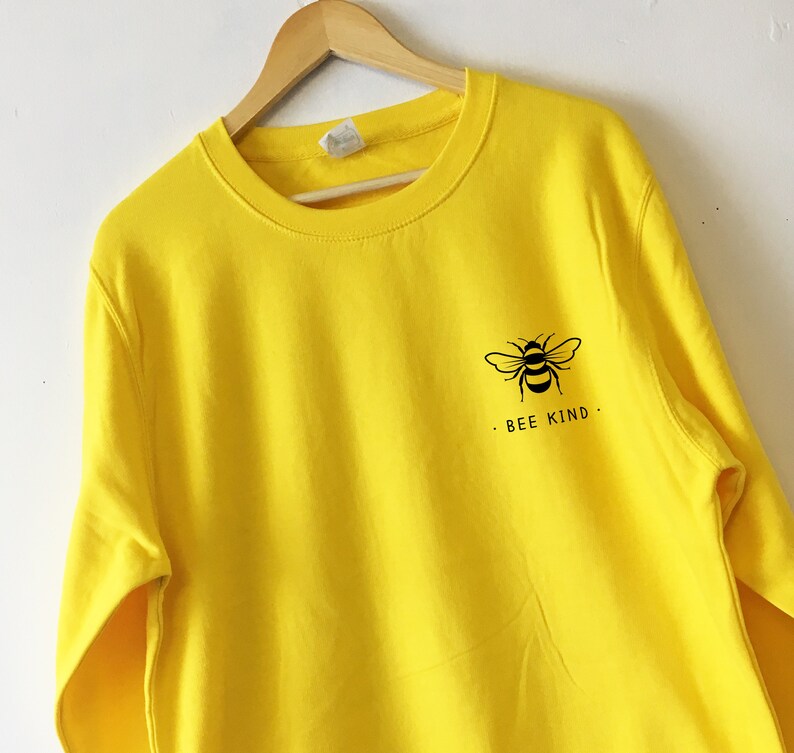 May include: Yellow sweatshirt with a black bee graphic and the text "BEE KIND."