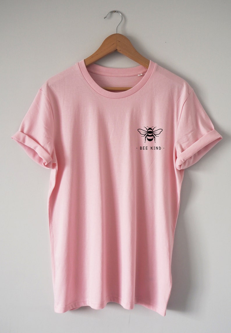 May include: A pink t-shirt with a black bee graphic and the text "Bee Kind" on the front.