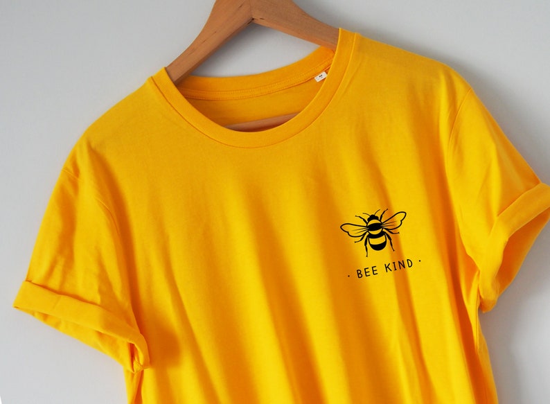 May include: A yellow t-shirt with a black bee graphic and the text "BEE KIND."