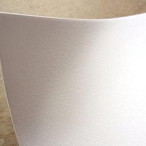 May include: A close-up of a white textured sheet of paper.