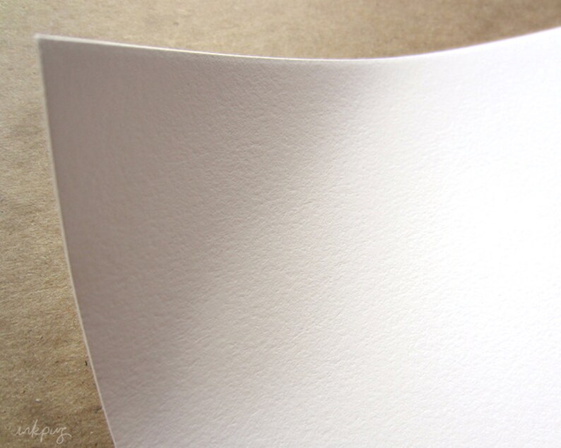 May include: A close-up of a white textured sheet of paper.